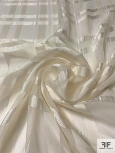 This luxurious Italian-made satin plaid silk chiffon in light ivory provides the perfect combination of style, comfort, and refinement. Soft to the feel and crafted with the highest quality materials, it is the ideal choice for anyone looking for a timeless garment. SKU: 14205 Content: 100% Silk Color: Light Ivory Width: 53 inches Origin: Italy Elegant Satin Finish Fabric For Wedding, Elegant Wedding Fabric With Satin Finish, Elegant Silk Fabric For Formal Occasion, Elegant Beige Fabric For Wedding, Elegant Beige Wedding Fabric, Elegant Cream Fabric For Wedding, Cream Silk Fabric For Wedding, Elegant Organza Fabric For Wedding, Elegant Wedding Organza Fabric