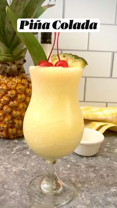 a pineapple drink in a glass on a counter