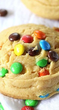 a close up of a cookie with m & m cookies in the middle and chocolate chips on the side