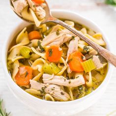 a white bowl filled with chicken noodle soup