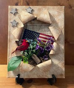 a wooden frame with flowers and an american flag