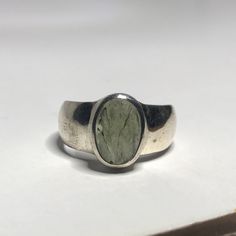 This genuine moldavite ring weighs 6.7 grams and measures to a US size 8 1/4. This rare stone sits in all sterling silver and a raw cut. Our Moldavite is guaranteed 100% genuine from the Czech Republic. Moldavite comes from a meteor collision with Earth almost 15 million years ago. Found only in the Czech Republic these green Gems are one of the most rare minerals on Earth. This tektite is composed of natural glass and is created when a meteorite collides with earth resulting in this green speci Modern Oval Silver Gemstones, Artisan Oval Hallmarked Jewelry, Modernist Oval Jewelry For Formal Occasions, Artisan Oval Silver Gemstones, Unique Oval Moonstone Ring For Formal Occasions, Modern Oval Sterling Silver Gemstones, Handmade Oval Emerald Ring, Unique Oval Rings With Large Stone, Modernist Oval Signet Ring As Gift