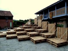 several wooden pallets are stacked on top of each other in front of a building