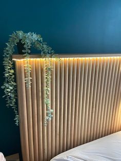 a bed with a plant on top of it next to a wall mounted radiator