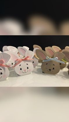 there are some paper rabbits in the shape of bunnies with bows on their heads