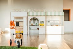 a toy bike in front of a flower shop