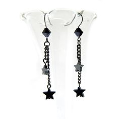 Make a wish upon a star with these Shooting Star Earrings. Handcrafted with hematite stars suspended from delicate gunmetal chains, these earrings are a perfect blend of edgy and elegant. Finished with a touch of jet black crystal detail, they're sure to add a celestial sparkle to any outfit. The French earring hooks ensure a comfortable fit that will keep you shining all day or night. Whether you're looking for a special occasion accessory or just a way to elevate your everyday look, these earr Black Star-shaped Metal Earrings, Butterfly Fashion, Prom 2024, Star Chain, Paper Stars, Shooting Star, Earring Hooks, Shooting Stars, Chain Earrings