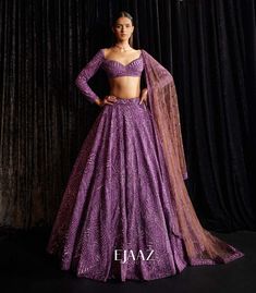 Turn heads in this exquisite purple lehenga set, which features a net-silk fabric bedecked with beautiful matching stones and studs all over it. The full sleeved sequined blouse and sheer net brown embellished dupatta will make you look like a modern day royalty.  Available at BIBI London. To book your appointment, call us at 07931 999111. Purple Reception Lehenga, Reception Lehenga Bridal Indian, Purple Lehenga Bridal, Reception Lehenga Bridal, Indian Engagement Outfit, Lehenga Purple, Indian Fits, Latest Lehenga Designs