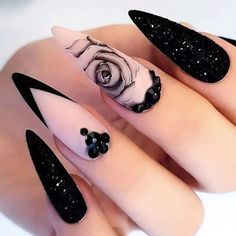 black and white nail art with roses on it's tips, one is shaped like a rose