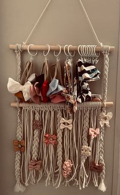 a macrame hanging on the wall with several different types of ties and bows