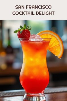 an orange drink with strawberries on the rim