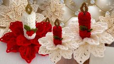 two crocheted candles are sitting on top of each other, one is red and the other is white