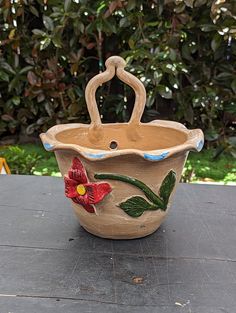 a ceramic flower pot sitting on top of a table