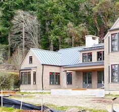 a large house sitting in the middle of a forest