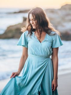 Designed with a figure-flattering wrap silhouette, our Rosa maxi dress features side on-seam pockets for added convenience. The tassel ties at the waist and fluttery ruffle hem just add to its bohemian chicness. The dress is partially lined and secures with a small hook-and-eye at the bust. With flutter sleeves, this dress embodies carefree elegance for your warm-weather adventures. Maxi wrap dress Side on-seam pockets Short flutter sleeves Partially lined Tassel ties at the back waist Hook-and- Fitted V-neck Breezy Maxi Dress, Spring Flowy Wrap Maxi Dress, Flowy Wrap Maxi Dress For Spring, Flowy Midi Wrap Dress For Vacation, Flowy Midi Length Wrap Dress For Vacation, Flowy Wrap Maxi Dress With Tie Waist, Flowy Wrap Dress For Brunch, Breezy V-neck Maxi Dress With Ruffles, Flowy Maxi Wrap Dress For Beach