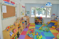 a child's playroom with toys on the floor