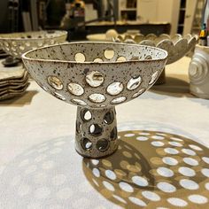 a metal bowl sitting on top of a table