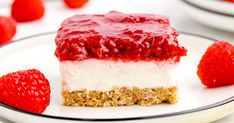 a piece of strawberry cheesecake on a plate with strawberries in the background,