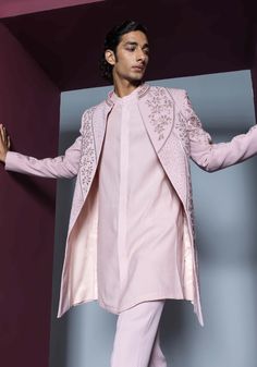 Radiate elegance in a pale pink open sherwani adorned with heavy dori and glass bead embellishments throughout. This ensemble is perfectly paired with a kurta and pants, creating a refined and sophisticated look that seamlessly blends intricate detailing with modern style for special occasions. Open Sherwani, Japanese Suit, Pink Sherwani, Kurta And Pants, Indian Wedding Wear, Wear Store, Beaded Neckline, Kurta With Pants, Band Collar