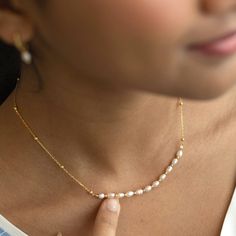 This stunning dainty necklace boasts a central strand of eleven 3mm rice freshwater pearls, delicately connected by 18K gold vermeil beads. The necklace is finished with a spring ring clasp and adjustable extender chain, making it a perfect treat for yourself or a loved one. Delicate Gold Beaded Necklace With Pearl Pendant, Rice Pearl Jewelry, Delicate Pearl Jewelry, Gold-tone Pearl Necklace With Adjustable Chain, Handmade Elegant 14k Gold-filled Pearl Necklace, Adjustable Delicate 14k Gold-filled Pearl Necklace, Elegant 14k Gold-filled Pearl Chain Necklace, Gold Jewels Design, Dainty Choker Necklace