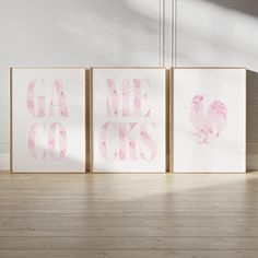 three pink and white prints with the words gamecocks printed on them in front of a light wood floor