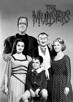 a group of people standing next to each other in front of a sign that says the monsters