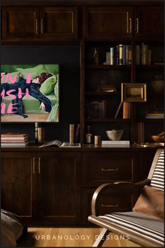 a living room filled with furniture and a flat screen tv mounted on a wall above a wooden entertainment center