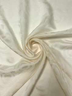 a white fabric with an intricate design on it