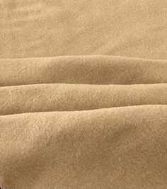 a close up view of a tan colored blanket