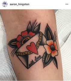 a tattoo with two hearts and flowers on it