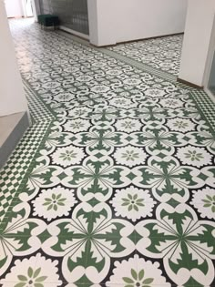 a green and white tiled floor in a room