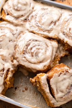 cinnamon rolls in a pan with icing on top