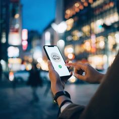 a person holding a cell phone in their hand and looking at the screen with an earth globe on it