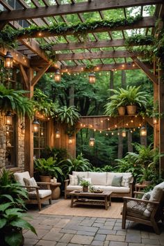 an outdoor living area with lots of plants and lights hanging from the pergolated roof