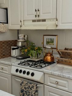 a white stove top oven sitting inside of a kitchen