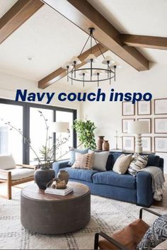 a living room with blue couches and pictures on the wall