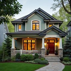 a house that has some lights on in front of the door and steps leading up to it