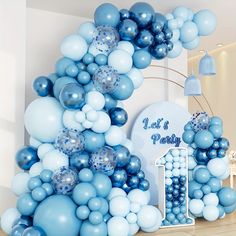 a blue and white balloon arch for a birthday party