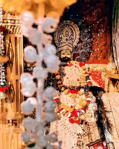 an elaborately decorated statue is seen through the glass window in front of some other decorations