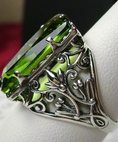 Simulated Green Peridot Ring Baguette Design#32 Custom Made Inspired by the intricate Victorian designs of the late 1800s, I now offer this gorgeous filigree Antique reproduction in sterling silver. The lovely ring is set with a flawless 7ct green peridot CZ gemstone. The baguette rectangle-cut Silver Leaf Art, Ring Baguette, Antique Filigree, Green Ring, Filigree Jewelry, Peridot Green, Vintage Inspired Jewelry, Vintage Style Jewellery, Sterling Silver Filigree