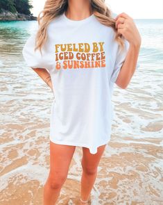 Fueled by Coffee & Sunshine Comfort Colors Tee | Beach Tshirt | Oversized Summer Tee | Trendy Beach Clothes DETAILS: Comfort Colors 1717 SIZES: Small-2X SIZE GUIDELINES: This Comfort Colors Shirt is a unisex fit that runs TRUE to size! If you want this to be comfortably fitted (NOT oversized), I recommend sticking with your regular size! -If you want it to fit slightly oversized, I recommend sizing up 1 size! -If you want it to fit very oversized (like the pictures), I recommend sizing up 2-3 sizes! Please allow 3-8 business days processing time for your item to be handmade just for YOU! All orders will ship via either USPS or UPS from Louisiana. Relaxed White T-shirt For Day Out, Relaxed Summer Tops With Screen Print, Relaxed Graphic Print Tops For Day Out, Relaxed Tops For Beach Season Day Out, Relaxed White Tops For Vacation, Summer Slogan T-shirt For Loungewear, Summer Tops With Screen Print For Day Out, White Text Print Tops For Beach, Summer Text Print T-shirt For Day Out