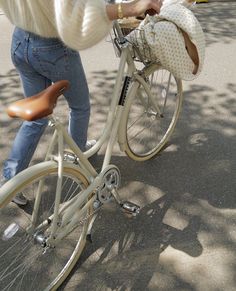 a woman riding a bike down a street