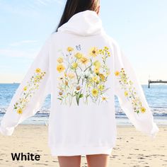 Elevate your wardrobe with this captivating and vibrantly colored hoodie, embellished with a stunning wildflower design across the back and sleeves. This hoodie is thoughtfully designed to bring a touch of nature's splendor into your daily wear. Adorned with bright and cheerful wildflowers, it exudes a sense of warmth and joy. Combining stylish flair with ultimate comfort, this hoodie is a must-have for anyone's collection. Whether you're enjoying a leisurely walk, spending a cozy evening indoor White Casual Hoodie With Floral Print, White Cotton Hoodie With Floral Print, White Floral Print Cotton Hoodie, Spring White Hooded Sweatshirt, Yellow Hoodie Sweatshirt For Spring, White Hooded Spring Sweatshirt, White Hooded Sweatshirt For Spring, White Floral Print Hoodie For Spring, Spring Cotton Hoodie With Floral Print