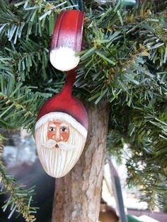 a christmas ornament hanging from a tree in the shape of a man's head