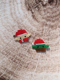 two pieces of lego art made to look like santa clause