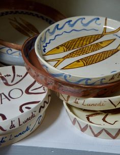 several bowls and plates with designs on them