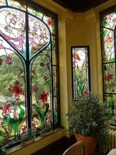 two large stained glass windows with plants in the middle and one on the other side