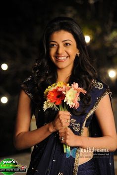 a woman holding a bouquet of flowers in her hands