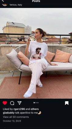 a woman sitting on top of a white couch