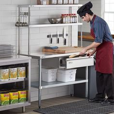 a man in an industrial kitchen preparing food